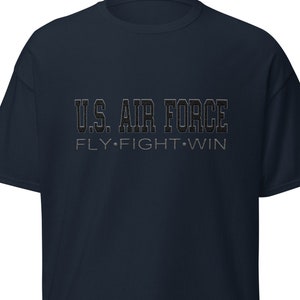 May include: A navy blue t-shirt with the text "U.S. AIR FORCE FLY.FIGHT.WIN" printed in black.