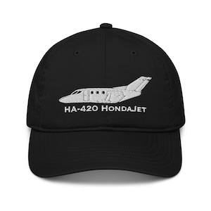 May include: Black baseball cap with a white embroidered image of a HondaJet HA-420 airplane and the text "HA-420 HONDAJET".