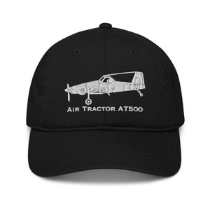 May include: Black baseball cap with a white embroidered image of an Air Tractor AT500 airplane and the text "AIR TRACTOR AT500".