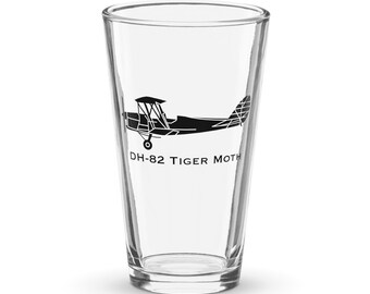 May include: A clear glass pint glass with a black silhouette of a DH-82 Tiger Moth airplane printed on the side.