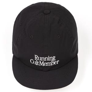May include: Black baseball cap with a curved brim. The cap features the white text "Running Cult Member" embroidered on the front. The cap has a button on top and a slightly textured appearance.