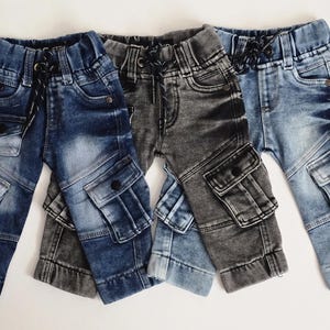 May include: Three pairs of blue denim cargo pants with multiple pockets. The pants have a drawstring waist and are made of a soft, comfortable fabric.