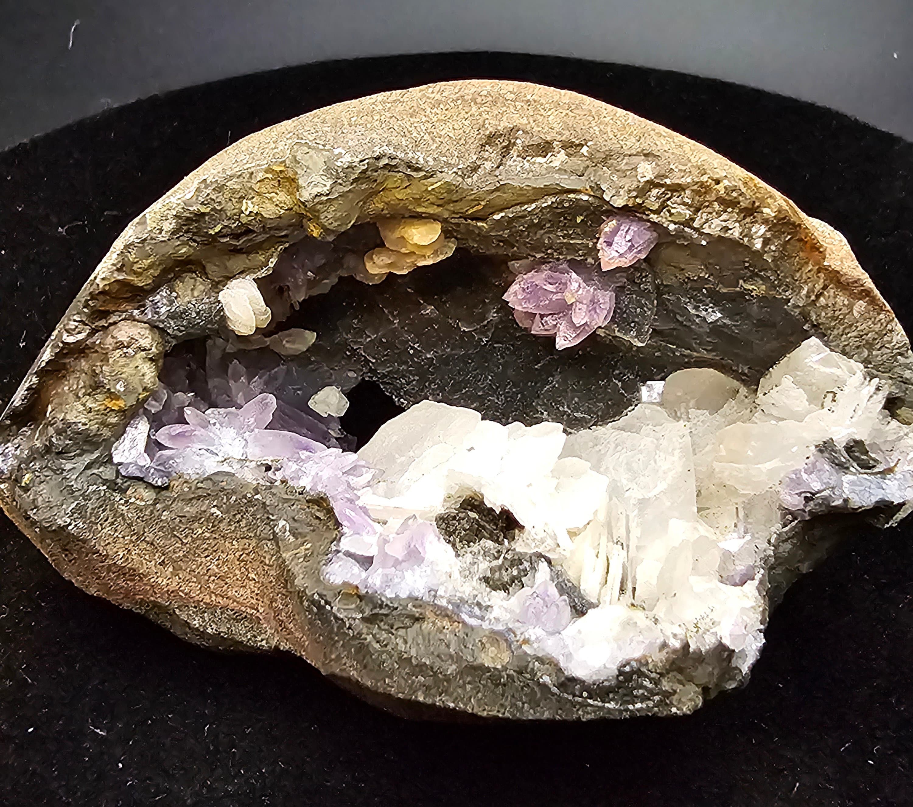 Amethyst Flowers on black chalcedony and stilbite blades in open face geode