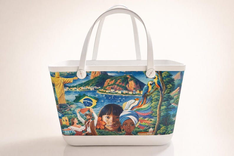 May include: White tote bag with a colorful illustration of Brazilian landmarks, people, and the Brazilian flag. The bag features a white handle and a white base. The illustration includes the Christ the Redeemer statue, mountains, and parrots.