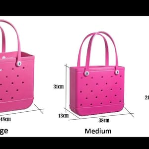 May include: Three pink tote bags of varying sizes. The large bag is 19 inches wide, 13 inches tall, and 9 inches deep. The medium bag is 15 inches wide, 12 inches tall, and 5 inches deep. The small bag is 11 inches wide, 8 inches tall, and 4 inches deep.