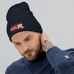 May include: A navy blue beanie with the text "CIVIC TYPE R" in white and red, with a rising sun design. The beanie is made of a soft material and is suitable for cold weather.