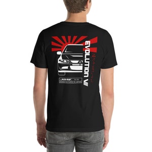 May include: Black t-shirt with a white silhouette of a Mitsubishi Lancer Evolution VII car, a red rising sun graphic, and the text "EVOLUTION VII" in red and white. The text "JDM 04/95 MANUFACTURED IN JAPAN" is also printed on the shirt.