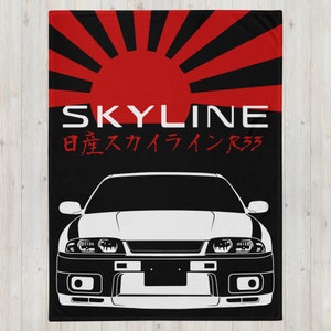 May include: Black and white silhouette of a Nissan Skyline R33 car with a red and black Japanese rising sun design in the background. The text "SKYLINE" and "日産スカイラインR33" is printed in white.