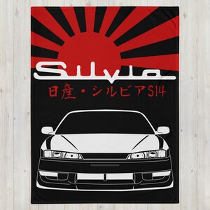 May include: A black and white illustration of a Nissan Silvia S14 with a red and black Japanese rising sun design in the background. The text "Silvia" and "日産・シルビア S14" is printed in white.