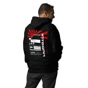 May include: Black hooded sweatshirt with a white graphic of a red sun rising over a white Honda Integra with the text "INTEGRA" and "JDM 98-95 MANUFACTURED IN JAPAN" in white.