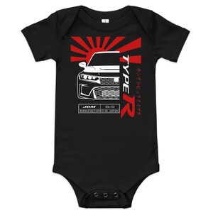 May include: Black baby bodysuit with a red and white graphic. The graphic features a car design with the word "TYPE R" in red, a rising sun design, and text that reads "JDM 09/23 MANUFACTURED IN JAPAN."