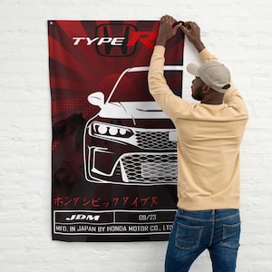 May include: A red and black banner featuring a white illustration of a car's front end, with the text "TYPE R" and Japanese characters. The banner also includes the text "JDM" and "09/23".