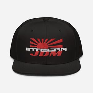 May include: Black baseball cap with a white embroidered "INTEGRA JDM" logo and a red rising sun graphic.
