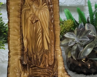 Guadalupe carved into Olive Wood branch