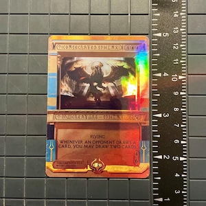 May include: A holographic trading card featuring a winged sphinx illustration. The card has text that reads "CONSECRATED SPHINX" and "FLYING". The card is approximately 3.5 inches tall.