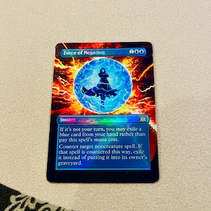 May include: A Magic: The Gathering card titled "Force of Negation." The card features a blue figure within a blue orb, set against a fiery orange and red background. The card text includes instructions for gameplay.