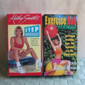 May include: Two VHS exercise video tapes. The left tape features Kathy Smith's Step Workout. The right tape features Jean Goulet-Klein's Exercise Ball Workout.