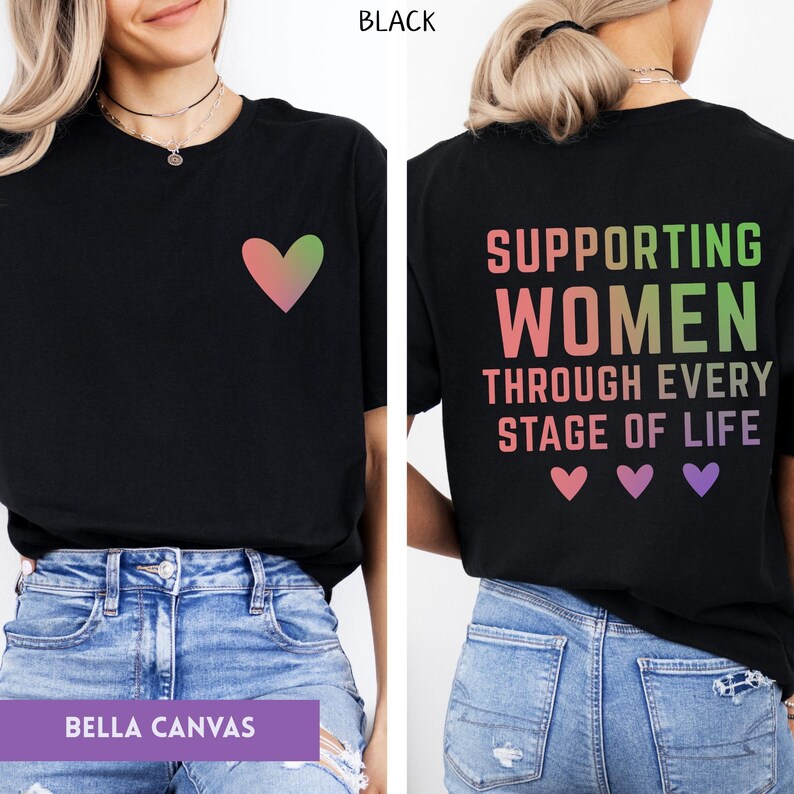 May include: Black t-shirt with a gradient heart graphic on the front. The back of the shirt features the text "SUPPORTING WOMEN THROUGH EVERY STAGE OF LIFE" with heart graphics. Made by Bella Canvas.