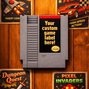 May include: A gray video game cartridge with a black label that reads "Your custom game label here!". The image is surrounded by vintage-style game posters with titles like "Galactic Blaster" and "Turbo Racer" on a wooden background.