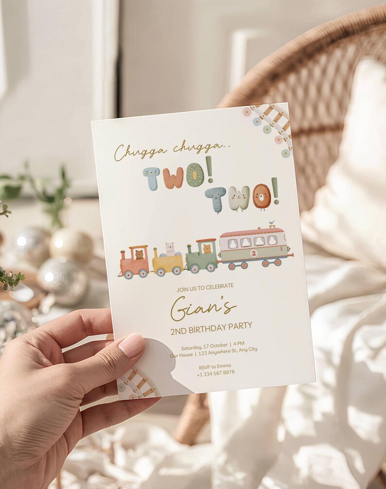 May include: A cream-colored birthday party invitation with a train theme. The text reads "Chugga chugga.. TWO! TWO!" and "Gian's 2nd Birthday Party." The invitation includes a train illustration with animal characters.