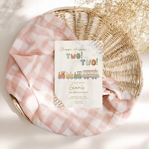 May include: A birthday party invitation with a train illustration. The invitation reads "Chugga chugga... TWO! TWO!" and "Join us to celebrate Gian's 2nd Birthday Party". The invitation is on a cream background with a colorful train design.