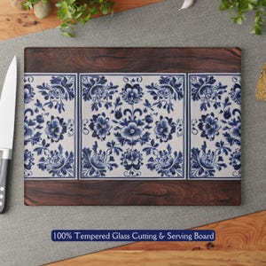 May include: A blue and white floral patterned tempered glass cutting and serving board with a dark wood frame.  100% Tempered Glass Cutting & Serving Board.