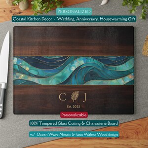 May include: A rectangular cutting board with a dark wood grain design. It features a mosaic ocean wave design in shades of blue and teal. The board is personalized with initials and the year 2025. The text on the board says "Coastal Kitchen Decor - Wedding, Anniversary, Housewarming Gift."