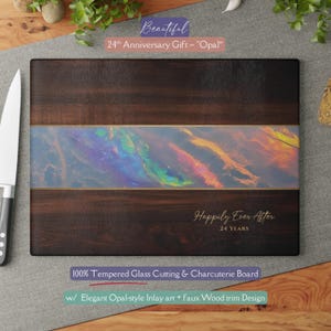 May include: A rectangular cutting board with a dark wood grain design. It features an opal-style inlay with gold trim and the text "Happily Ever After 24 YEARS". The board is labeled as a 24th Anniversary Gift.