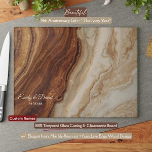 May include: A rectangular cutting board with a marble-resin design and faux wood edge. The board is personalized with the names "Emily & David" and the text "14 YEARS". The text "14th Anniversary Gift - The Ivory Year" is also visible.