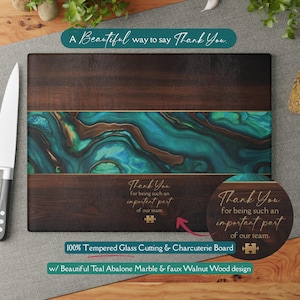 May include: Tempered glass cutting and charcuterie board with a teal abalone marble design and faux walnut wood. The board has the text "A Beautiful way to say Thank You" and "Thank You for being such an important part of our team."
