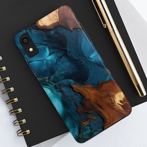 May include: A phone case with a blue and brown abstract design. The design features swirling blue and gold patterns with brown wood grain accents.