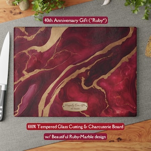 May include: A rectangular tempered glass cutting and charcuterie board with a ruby-marble design. Gold veins flow across the deep red surface. Text reads "40th Anniversary Gift" and "Happily Ever After, 40 Years".