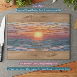 May include: Tempered glass cutting and serving board with an ocean sunset design. The board features a faux wood border and opalescent stained glass-inspired art. The text on the board says "Beautiful Functional Coastal Kitchen Decor, Housewarming Gift".