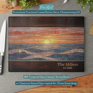 May include: A rectangular cutting board with a sunset design. The top and bottom are dark wood, and the center features an ocean sunset in stained glass style. Text reads "The Millers Est. 2026".