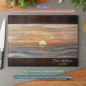 May include: A rectangular cutting board with a stained glass-inspired ocean sunset design. The board features a faux wood border and the text "The Millers Est. 2026". It is made of tempered glass.