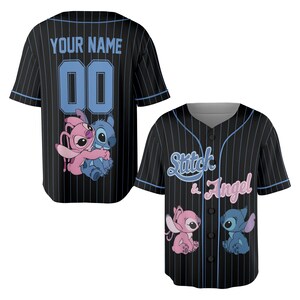 May include: Black baseball jersey with blue pinstripes. The front features the text "Stitch & Angel" and cartoon characters. The back has the text "YOUR NAME" above the number "00" in blue.