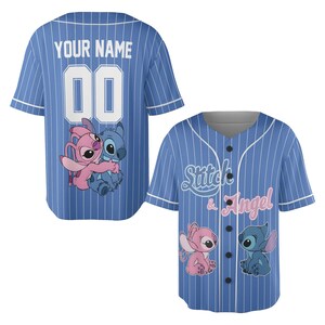 May include: Blue baseball jersey with white pinstripes, featuring the text "YOUR NAME" and the number "00" on the back. The front displays "Stitch & Angel" and cartoon characters. Short-sleeved, button-up design.