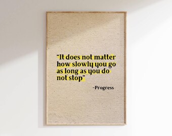 May include: A motivational quote printed on a beige background with a wood frame. The quote reads "It does not matter how slowly you go as long as you do not stop" -Progress.