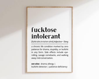 May include: A framed print with the words "fucktose intolerant" in bold black font. The definition is provided below, describing a slang term for a chronic life condition. The print is in a wooden frame.