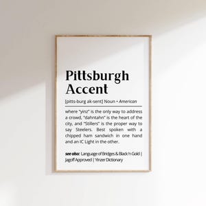 May include: A black and white printable poster with the definition of the Pittsburgh accent. The text reads "Pittsburgh Accent [pitts-burg ak-sent] Noun American where 'yinz' is the only way to address a crowd, 'dahntahn' is the heart of the city, and 'Stillers' is the proper way to say Steelers. Best spoken with a chipped ham sandwich in one hand and an IC Light in the other. see also: Language of Bridges & Black'n Gold | Jagoff Approved | Yinzer Dictionary"