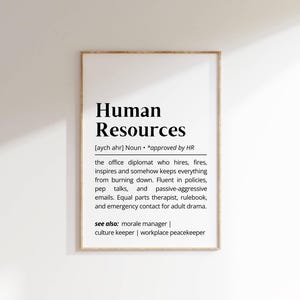 May include: A framed print featuring the words "Human Resources" in bold black lettering. The text below defines the role, mentioning hiring, firing, and preventing things from failing. It concludes with "see also: morale manager | culture keeper | workplace peacekeeper."