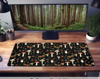 May include: A black desk mat with a repeating pattern of mushrooms, butterflies, and beetles on a black background. The text "3 Sizes Available" is printed below the mat.
