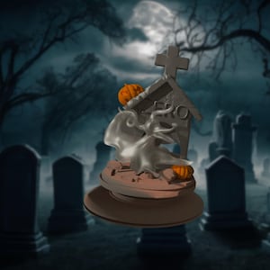 Op de afbeelding: Een keramiek Halloween-figuur van een geest met een pompoen op een grafsteen. De grafsteen heeft het woord "Zero" erop geschreven. Het figuur staat op een bruine basis.