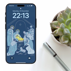 Peut inclure: Une illustration bleue et blanche de la scène de la Nativité sur l'écran d'un smartphone. L'heure est 22h13 et la date est samedi 23 décembre.