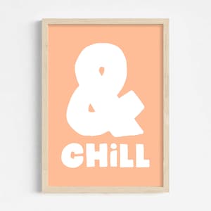 A poster with a peach fuzz pink backgroud and white text in a bold hand written font saying: "& Chill".