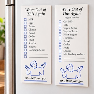 May include: Two white rectangular magnetic grocery lists with blue text and graphics. The left list is titled We're Out of This Again with items like Milk, Eggs, and Common Sense. The right list is titled Vegan Version with items like Oat Milk and Tofu. Both feature a blue line drawing of a person shrugging with the text so... here you go-.