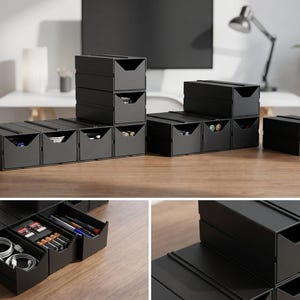 May include: A set of modular black storage drawers with open-front designs, arranged in various stacked and side-by-side configurations. The drawers contain organized items including white charging cables, small batteries, and various pens.