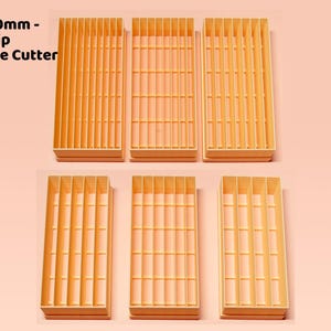 May include: Six light orange rectangular long strip cutters are shown. The cutters have vertical slots and are labelled "4mm - 10mm - Long Strip Rectangle Cutter Set."