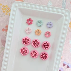 May include: A white ceramic mug with a black handle and the text "But First, Coffee" in a bold, black font. The mug is set against a plain white background, highlighting its simple design.