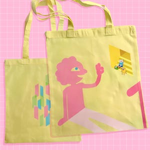 May include: Two yellow tote bags with pink and blue graphics. One bag features a pink figure waving, while the other has a geometric design. The bags have yellow handles and are set against a pink grid background.